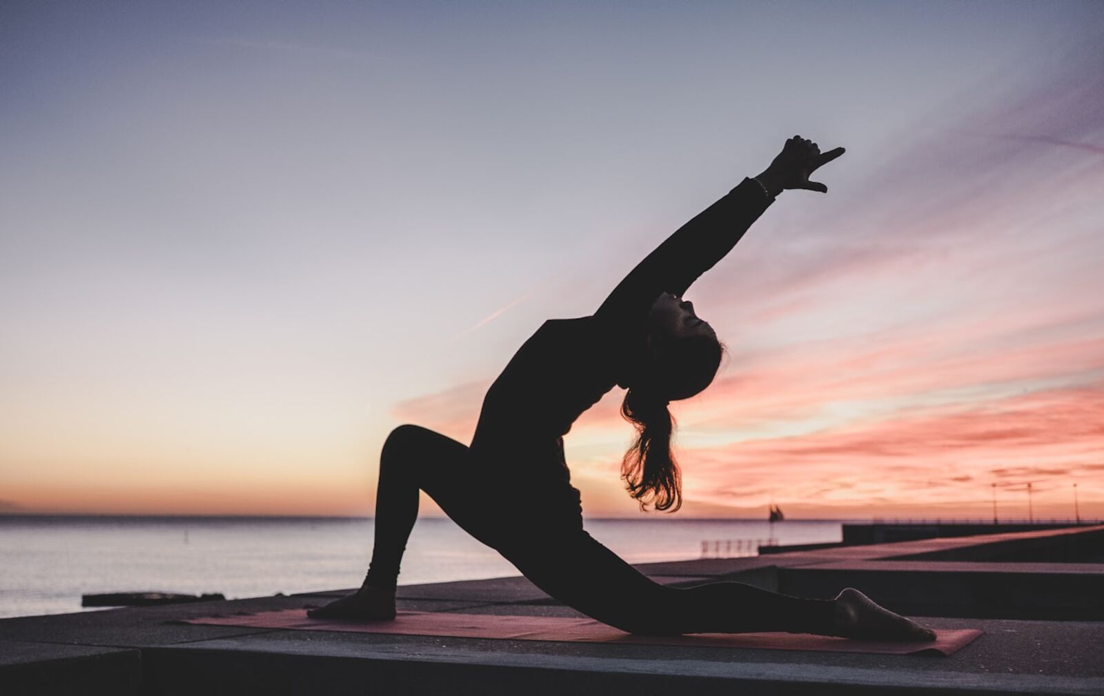 A calm sunrise stretch by the sea, part of a healthier routine